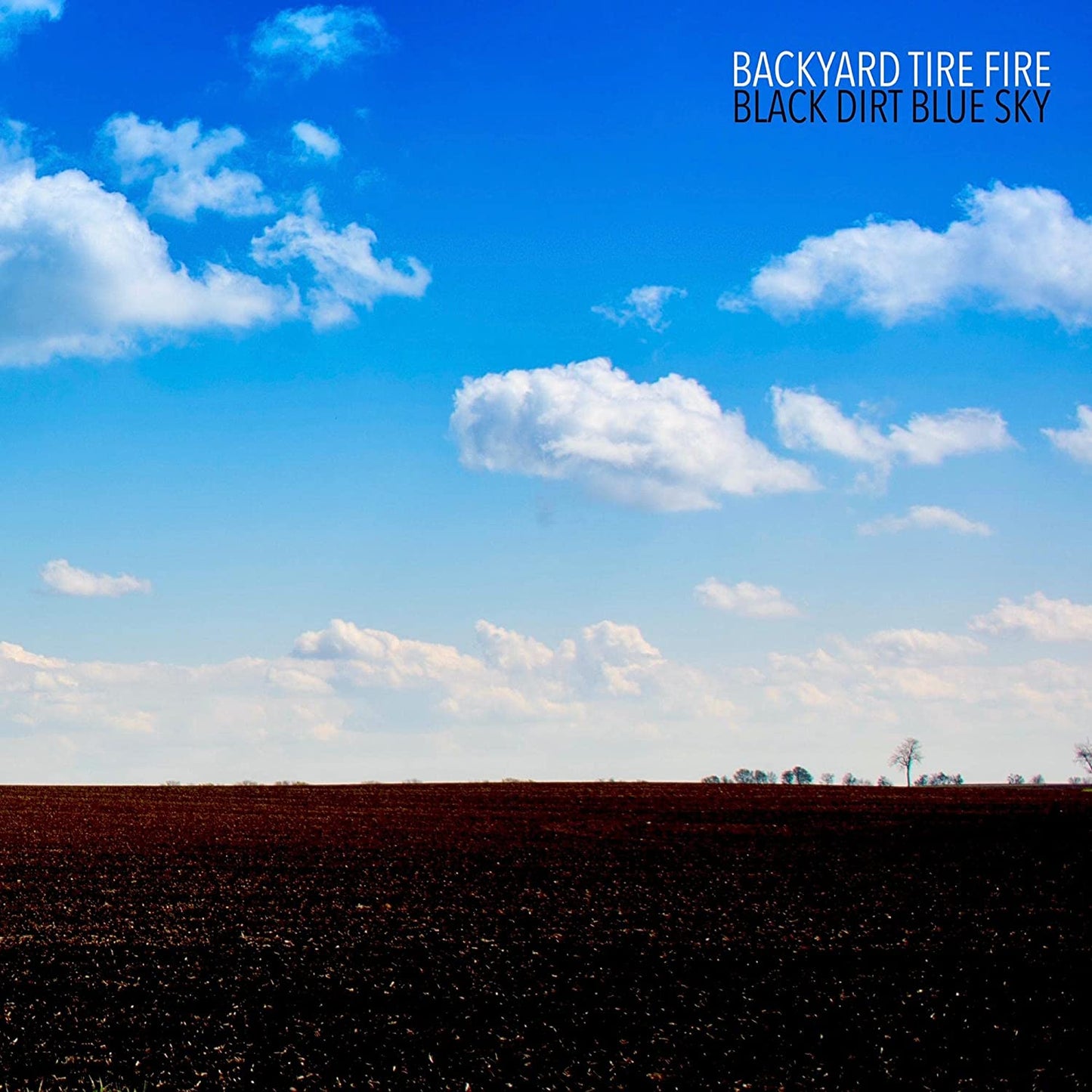 Backyard Tire Fire- Black Dirt Blue Sky